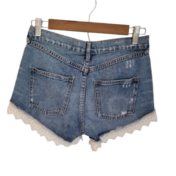 Free people | High-Waisted Medium Wash Jean Shorts with Distressing and Lace Hem - Picture 3 of 8